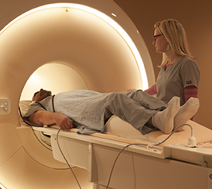 Technician preparing man for MRI scan.